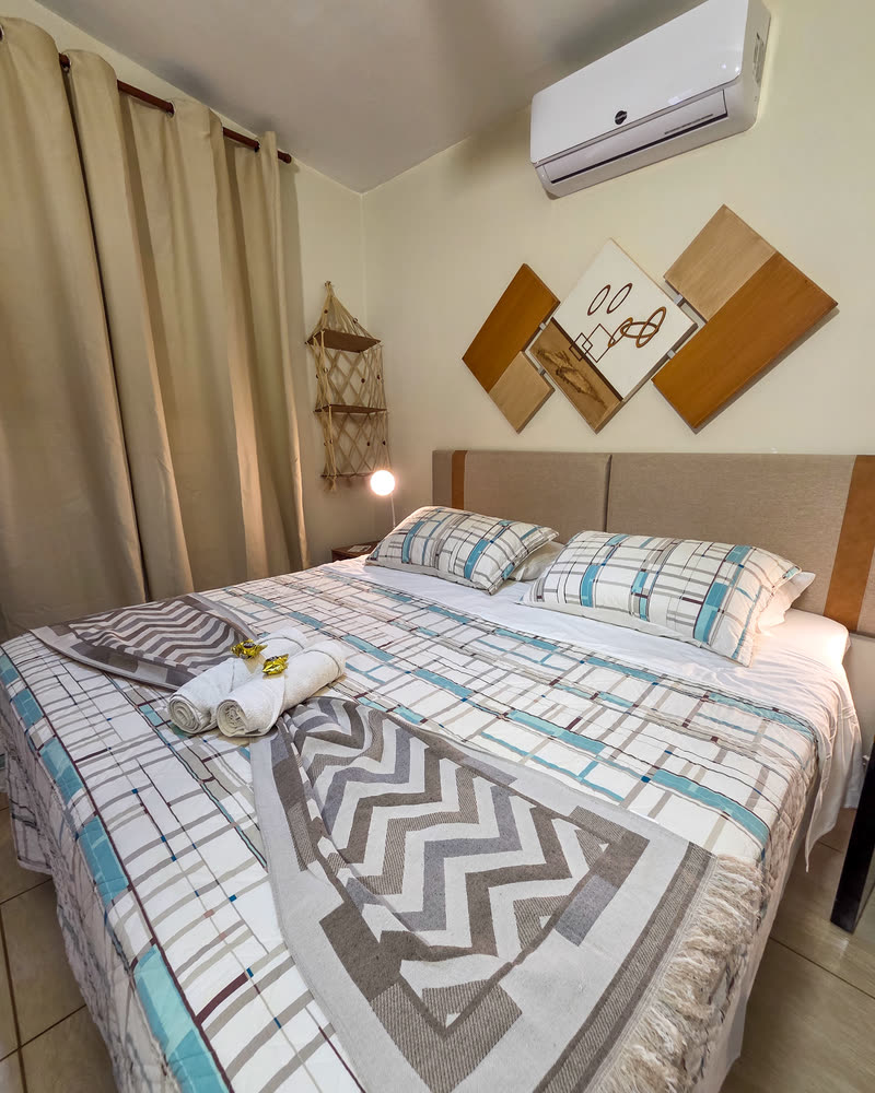 Suíte do Chalé Beija-flor com cama de casal e decoração aconchegante